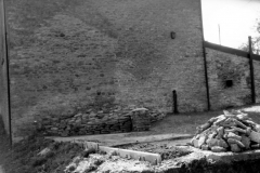 April 1989 North wall of the chapel showing traces of old cottages. Foundations and rubble from the cottages were incorporated into a garden.