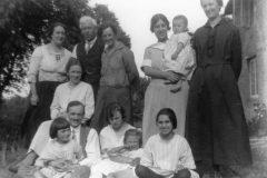 c. 1922 House on the bank. May Squires and her husband. Left: Miriam Dallinger. The baby is her daughter, Jean. Betty Dallinger is in the centre of the front row.