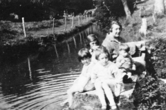 1920s Children by the mill stream - Left to right: Jean and Betty Dallinger, Joan and Roy Eaglestone. Miriam Dallinger in the background.