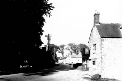 c.1920. Enstone Road looking east. On the north side, the Castle family workshop. On the south side, the Fox pub and numbers 11 - 15.