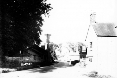 c.1920. Enstone Road looking east. On the north side, the Castle family workshop. On the south side, the Fox pub and numbers 11 - 15. Replicate.