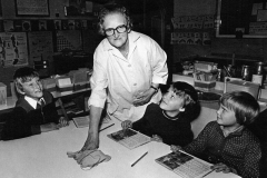 1976 Press photograph of Mrs. Hilda Cox taken on her retirement from the position as Caretaker of Middle Barton School, with her grandsons Paul, Robin and Neil.