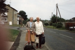 1988 Mrs. Winifred Pritchard and Mrs. Lilian Davis in Enstone Road on their way to Westcote Barton churchyard.