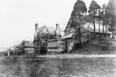 The teacher's house is in the centre of the photograph. The fenced area on the left was the teacher's garden.