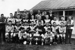 Duns Tew back row: Ted Harper, Charlie Gibbons, Bob Shroder, K. Bauckham, W. Wood, ? Brain. Next: Johnnie Brooks, Bob Stewart, Robin Cox, Tom? John Bolton, Ron Gascoigne, Ralph Miller, Derrick Jarvis, Mervyn Cox, David Jarvis, George Hughes.
