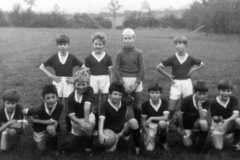 c. 1969 Middle Barton School Team. Back: Neil Shirley, Trevor Stewart, Stephen Monk, Edmund Sokol. Front: ?, Tim Fowler, Melvin Wetherall, John Fowler, ?, ?, Keith Morley, John Bunce. Colours were maroon and white (info from Ed Sokol).