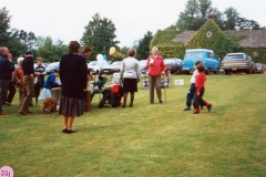 June 1987 Steeple Barton Church fete at Barton Abbey. Mrs. Joan Fleming (in red).