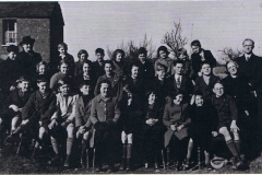 1940. Evacuees from St. Anthony's School, Forest Hill at Steeple Aston School. Mr Webster, headteacher of St. Anthony's, and his wife on the right and left of the photo. Their son is standing next to Mrs. Webster.