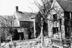Rear view of the Old Malt House, Fox cottage on the right. Miss Sullivan and her dog.